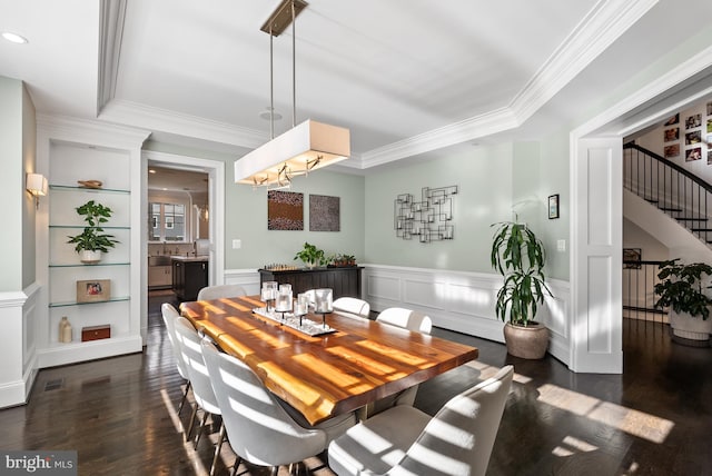 dining space with ornamental molding, dark hardwood / wood-style floors, and built in shelves