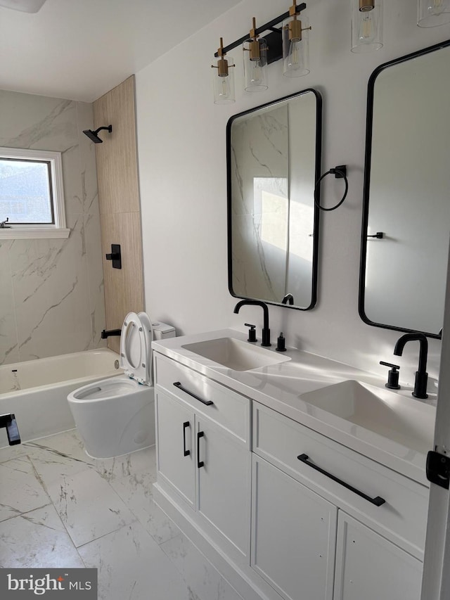 full bathroom with toilet, vanity, and tiled shower / bath