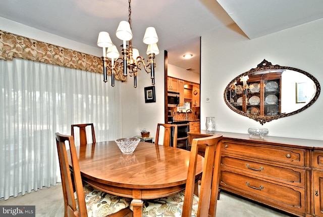 dining area with a notable chandelier and light carpet