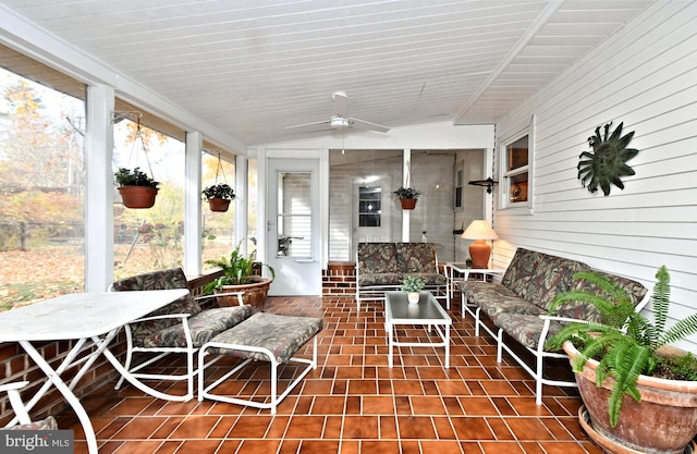 sunroom with ceiling fan and lofted ceiling