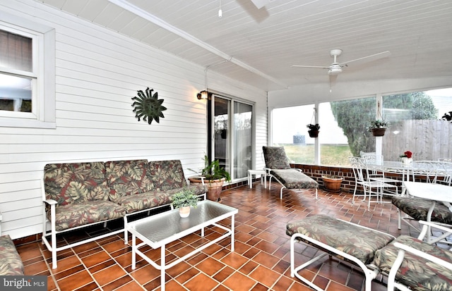 sunroom with ceiling fan, wood ceiling, and vaulted ceiling