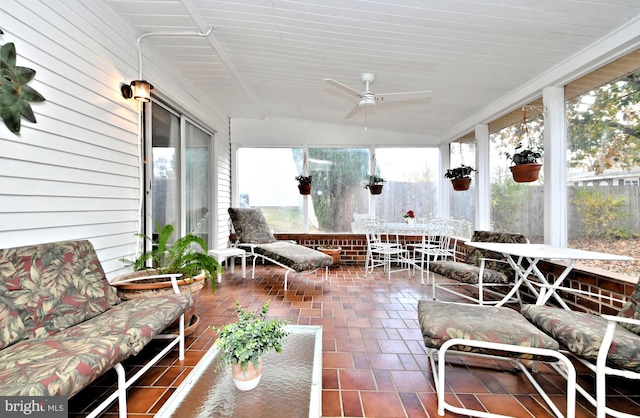 sunroom featuring ceiling fan, wooden ceiling, and vaulted ceiling