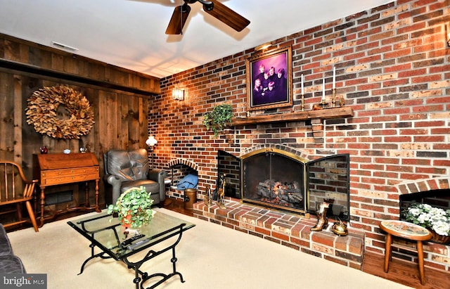 living room featuring light colored carpet, a brick fireplace, and wooden walls