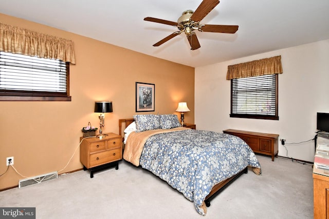 bedroom with ceiling fan and carpet floors