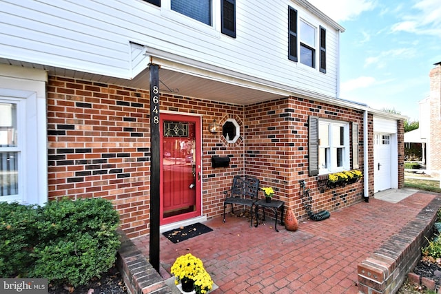 entrance to property with a porch and a garage