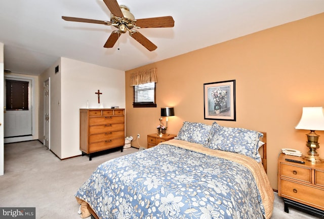 carpeted bedroom with ceiling fan and a baseboard radiator