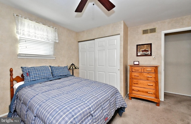 bedroom with carpet, a closet, and ceiling fan