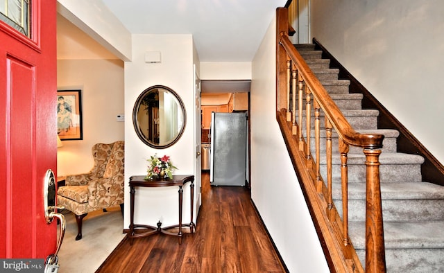 stairs featuring wood-type flooring