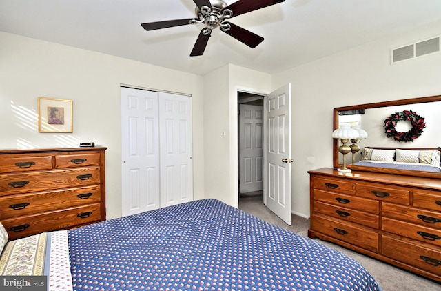 carpeted bedroom featuring a closet and ceiling fan