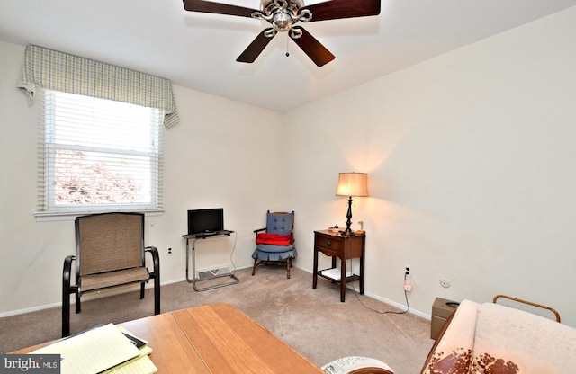 sitting room with ceiling fan and light carpet