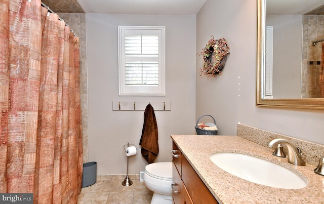 bathroom featuring tile patterned flooring, vanity, and toilet