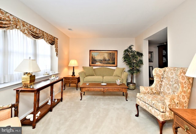 sitting room featuring light colored carpet