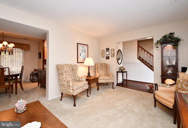 sitting room with light colored carpet and an inviting chandelier