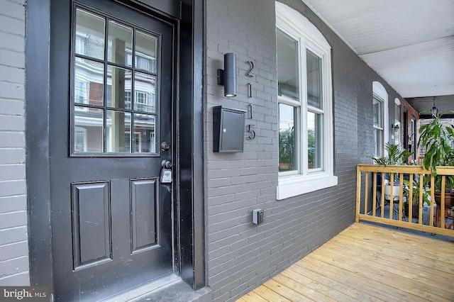 view of exterior entry featuring covered porch