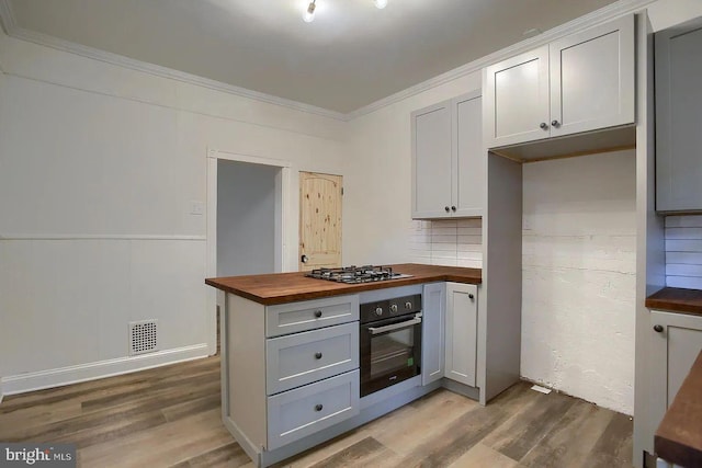 kitchen with stainless steel appliances, tasteful backsplash, wooden counters, crown molding, and light wood-type flooring