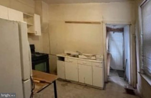 kitchen with white cabinets and white refrigerator