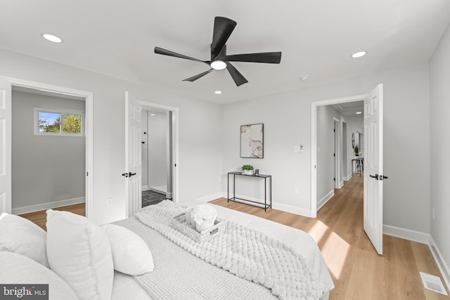 bedroom with light wood-type flooring and ceiling fan