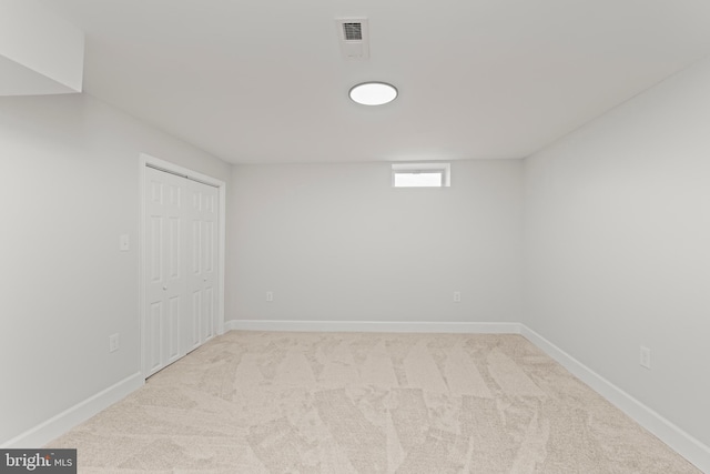 basement featuring light carpet