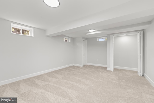 basement featuring light colored carpet