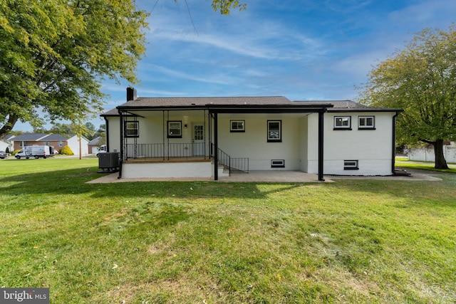 back of house featuring a patio area and a yard