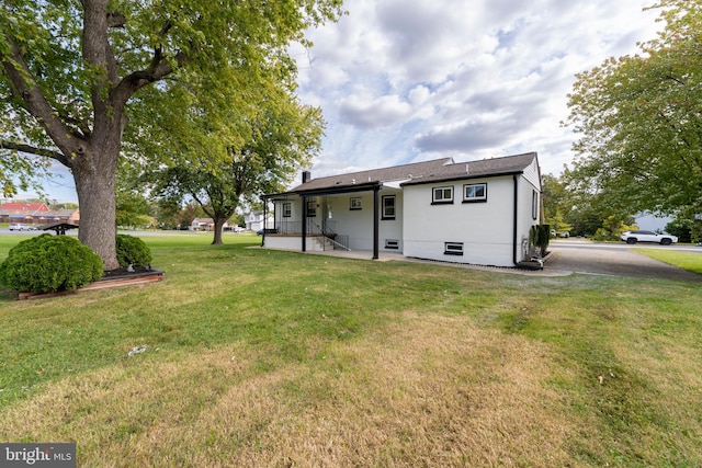 back of house with a lawn