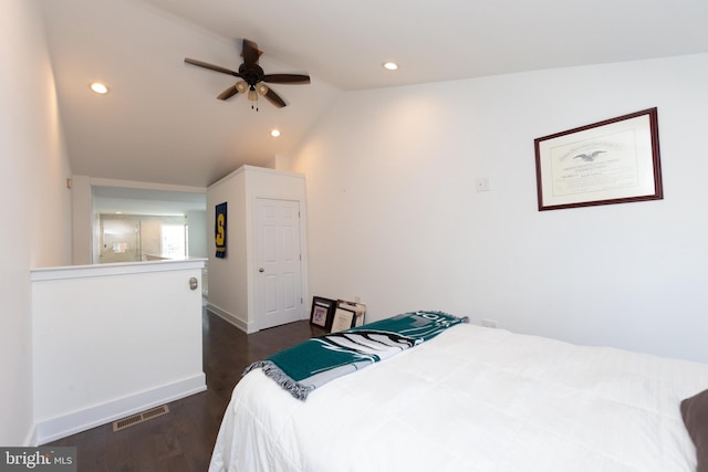 bedroom with vaulted ceiling, ceiling fan, and dark wood-type flooring