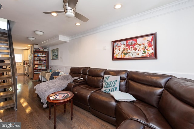 living room with hardwood / wood-style flooring, ceiling fan, and crown molding