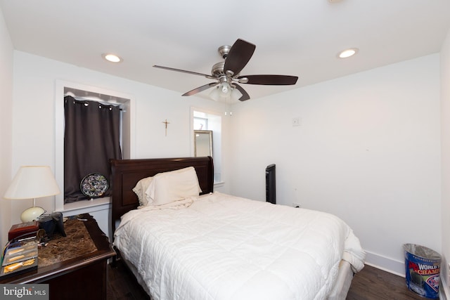 bedroom with dark hardwood / wood-style floors and ceiling fan