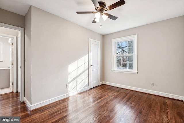 empty room with ceiling fan and dark wood-type flooring