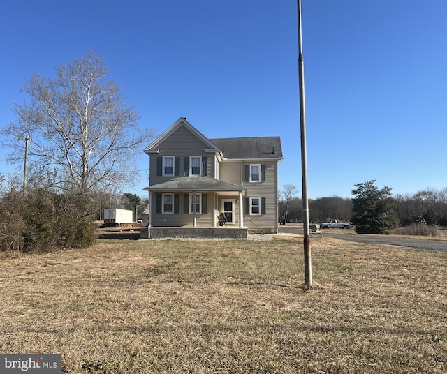 view of front property featuring covered porch and a front lawn