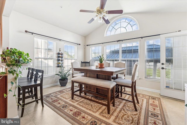 dining space featuring high vaulted ceiling and ceiling fan