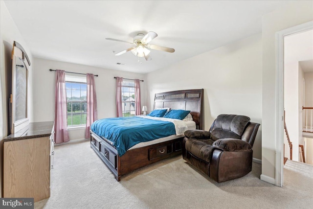 bedroom with ceiling fan and light carpet