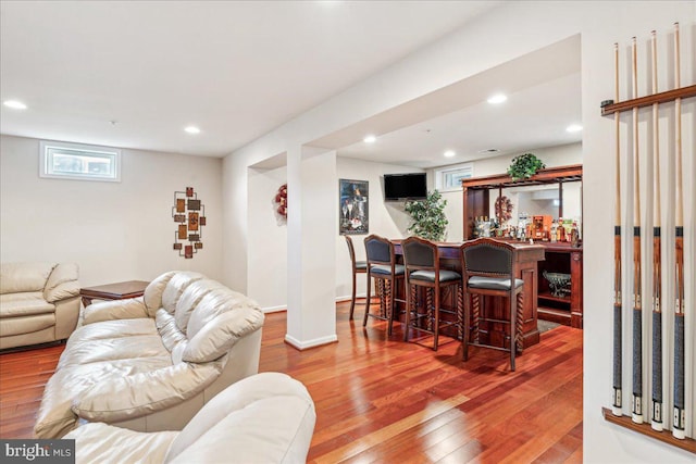 living room featuring bar area and wood-type flooring