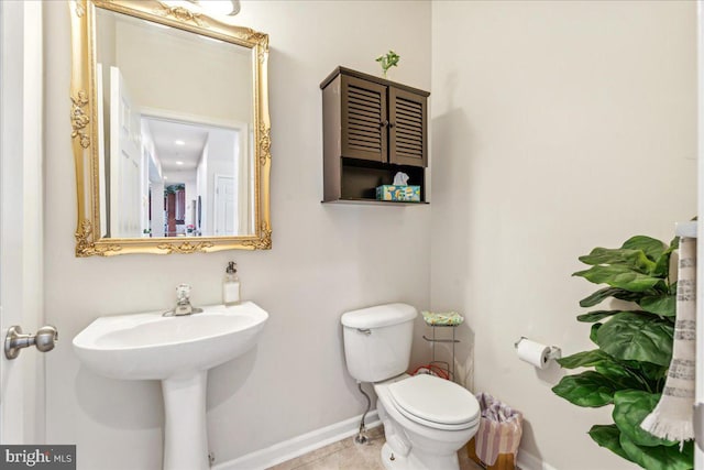 bathroom featuring tile patterned floors and toilet