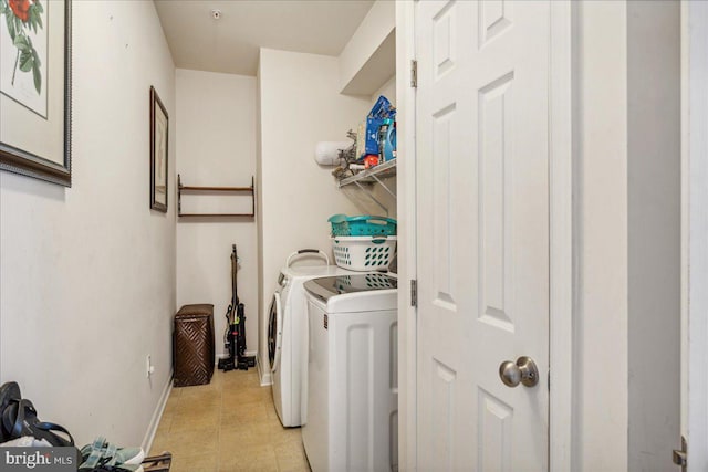 clothes washing area featuring separate washer and dryer