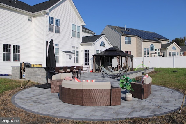 back of house with a gazebo, an outdoor living space, and a patio