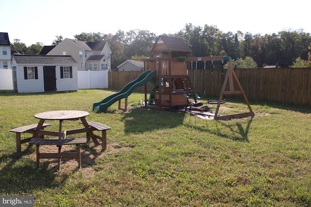 view of play area with an outbuilding and a yard