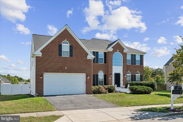 view of front of house with a front yard and a garage