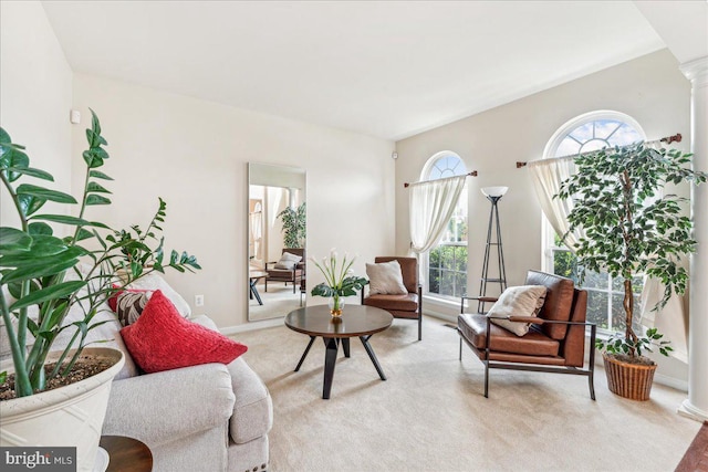 sitting room with light carpet and decorative columns