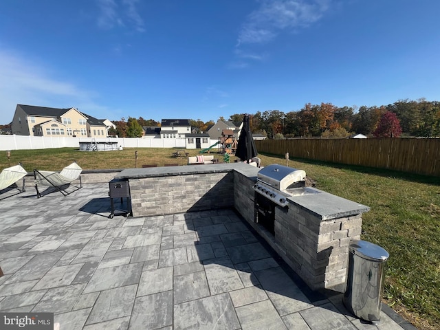 view of patio / terrace with an outdoor kitchen and grilling area