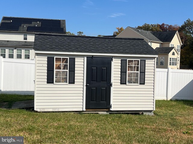 view of outdoor structure featuring a lawn