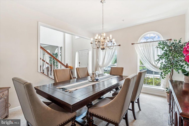 carpeted dining area featuring a chandelier