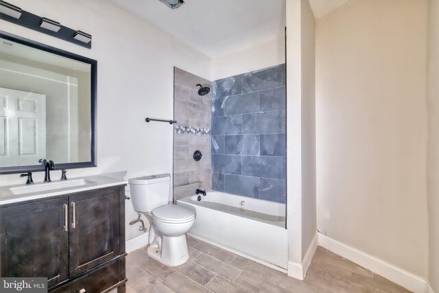 full bathroom with vanity, toilet, and tiled shower / bath