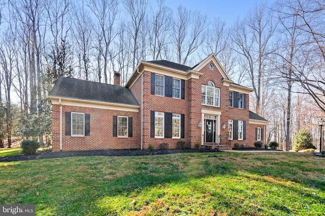 colonial-style house with a front yard