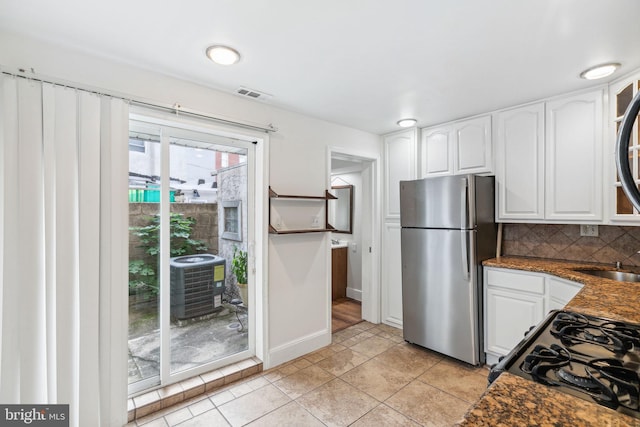 kitchen with white cabinetry, sink, tasteful backsplash, stainless steel fridge, and light tile patterned flooring