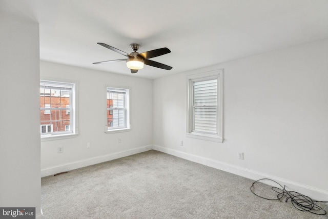 carpeted empty room featuring ceiling fan