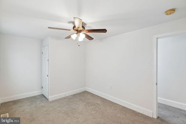 empty room with ceiling fan and light colored carpet