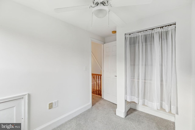 unfurnished bedroom with light colored carpet and ceiling fan