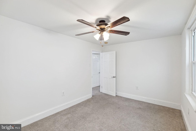 spare room featuring ceiling fan and light colored carpet