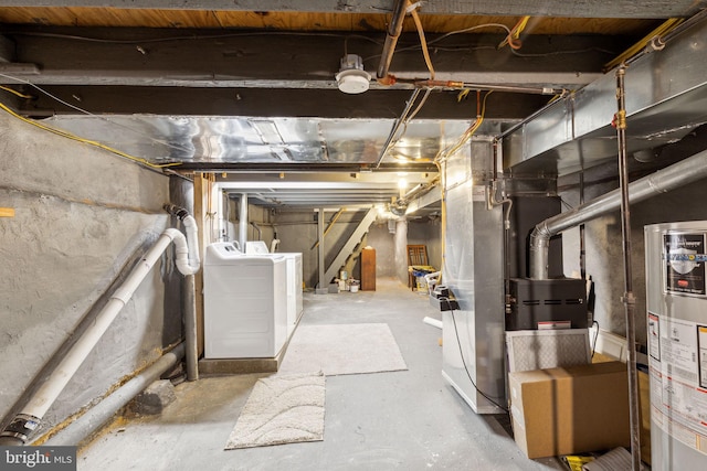 basement with washing machine and dryer, gas water heater, and heating unit